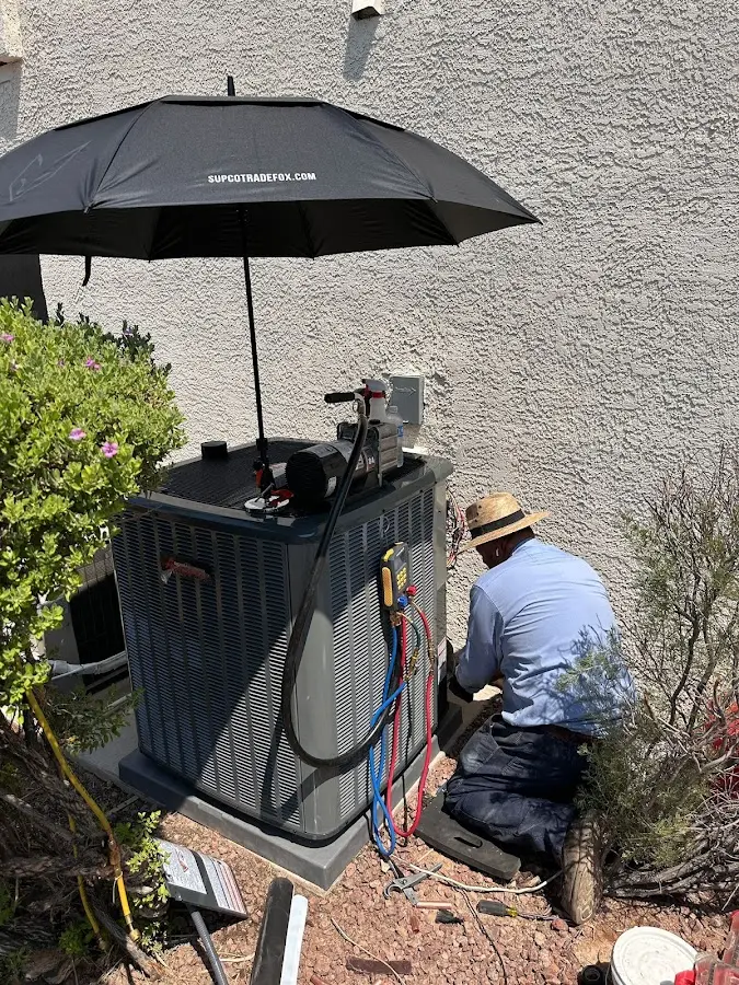 HVAC technician performing outdoor AC maintenance in Yukon